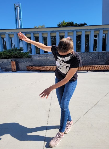 A student is trying to balance on a line. However, she is wearing glasses that make her see distorted. This makes the task more difficult for her.
