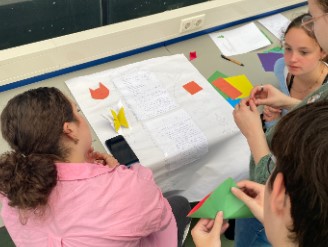 Three schoolgirls working together on a poster.